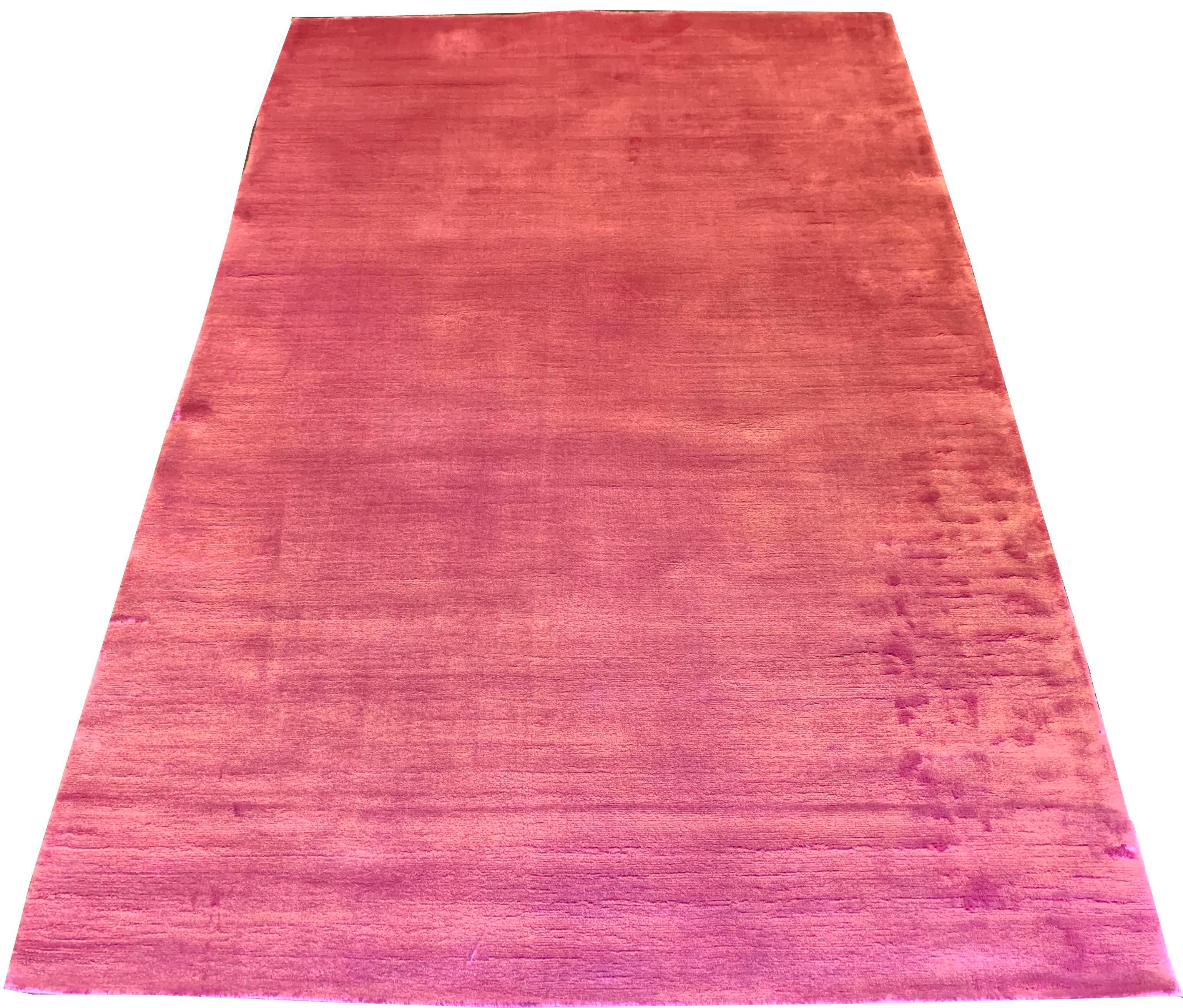 Close-up perspective of hand-knotted bamboo silk rug 7784 highlighting the vibrant rosy shimmer and plush velvety pile.
