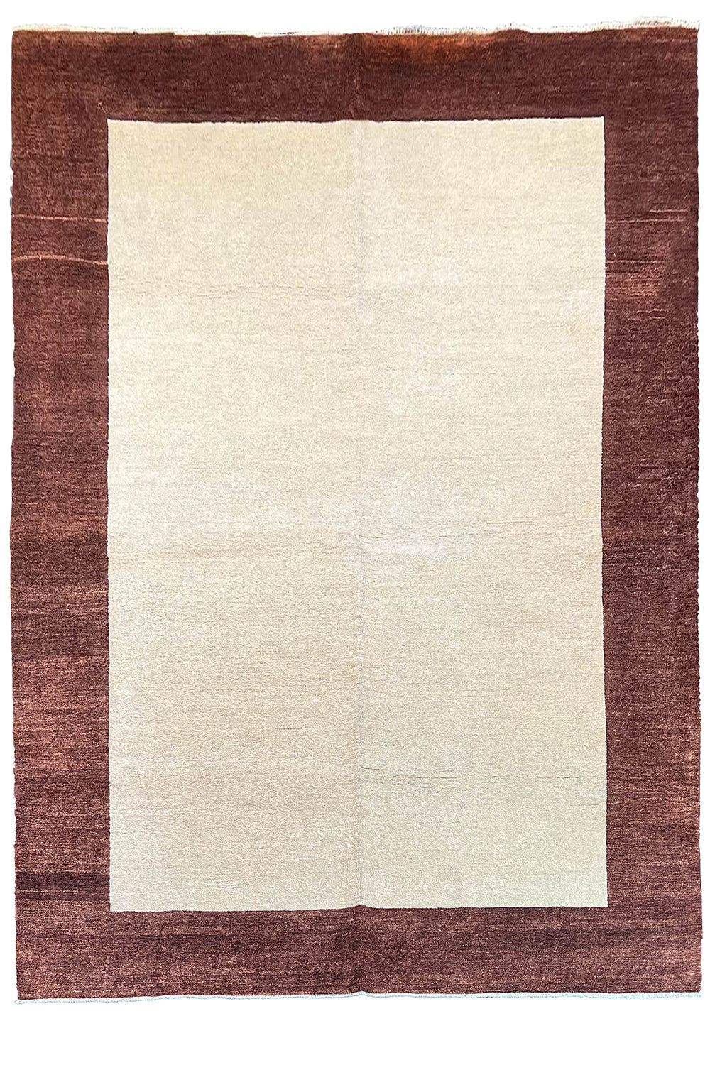 Flat lay top view of hand-knotted Gabbeh rug 3741; solid ivory field framed by a thick chocolate brown border.