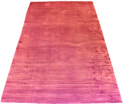 Close-up perspective of hand-knotted bamboo silk rug 7784 highlighting the vibrant rosy shimmer and plush velvety pile.