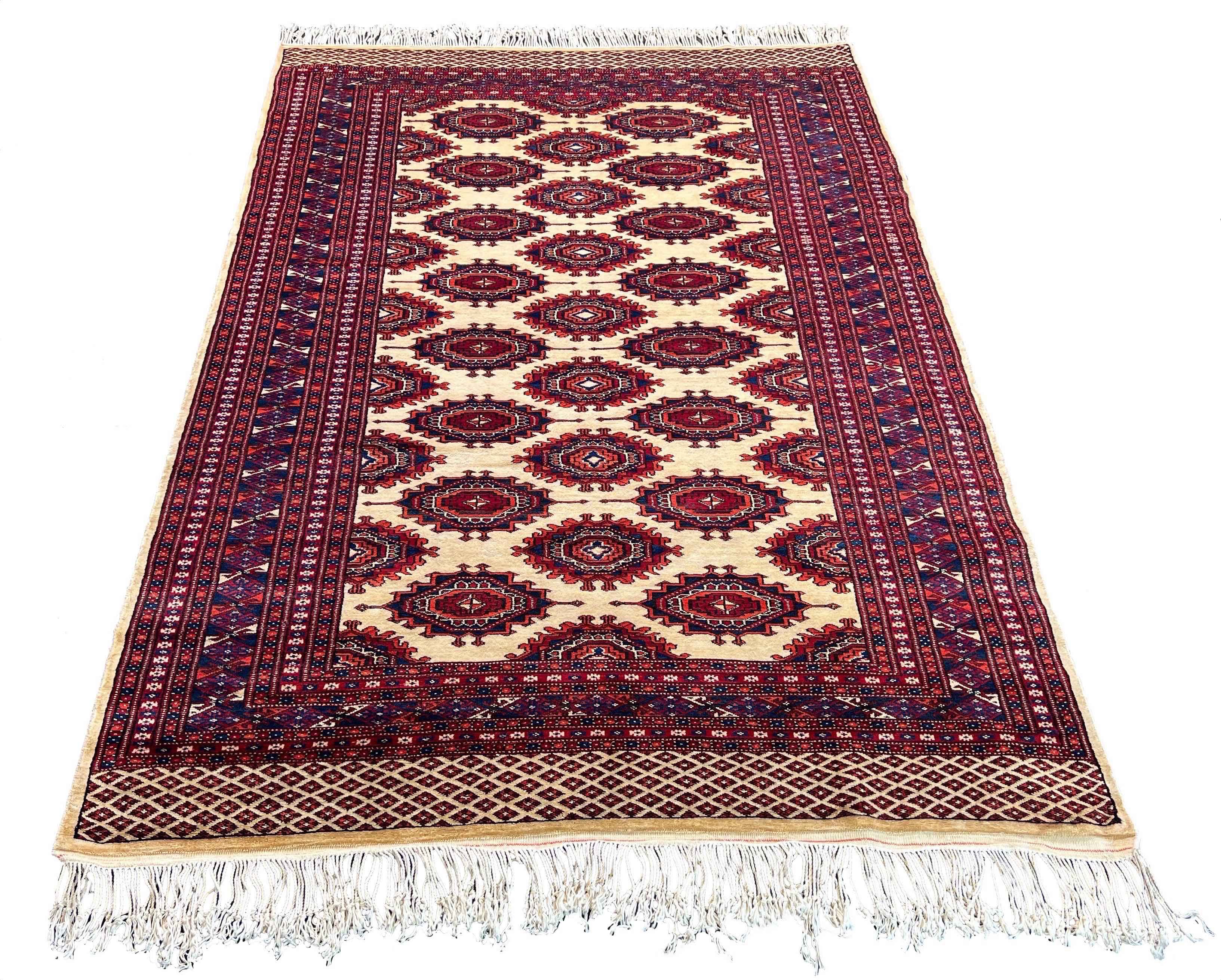 Regal hand-knotted Pakistan Sarooq rug featuring deep ruby red and indigo floral medallions on a cotton base #3387.