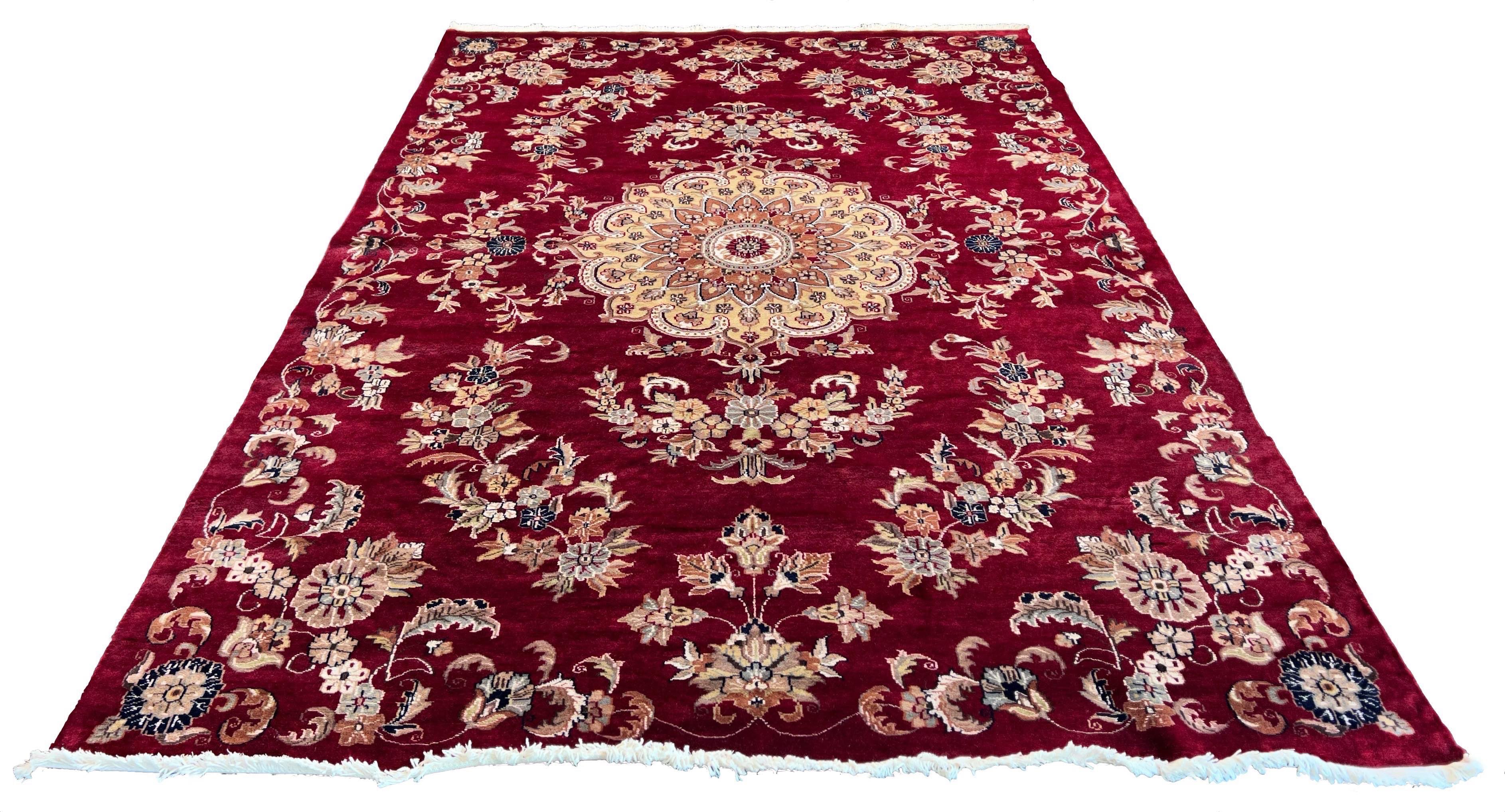 Ornate handmade Pakistan Isfahan rug with a cherry red field, cream central medallion, and floral arabesques #6513.